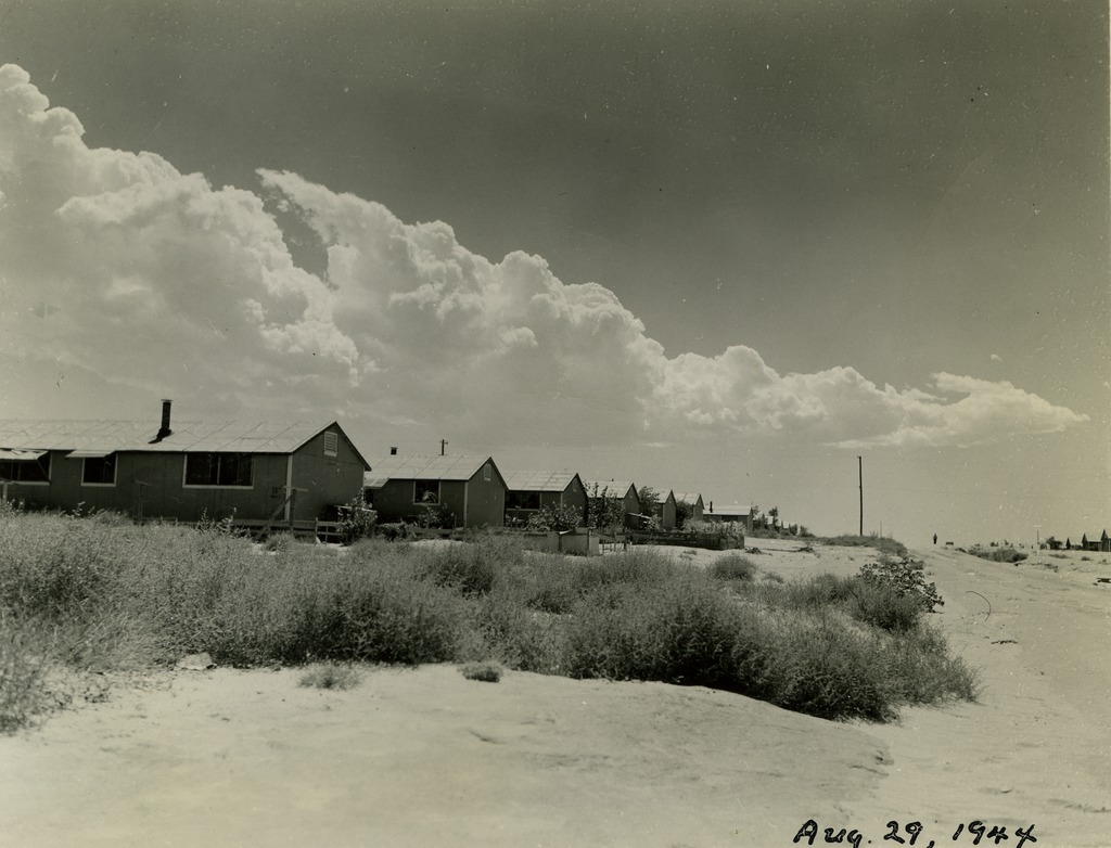 A dusty street lined with barracks in Amache concentration camp.