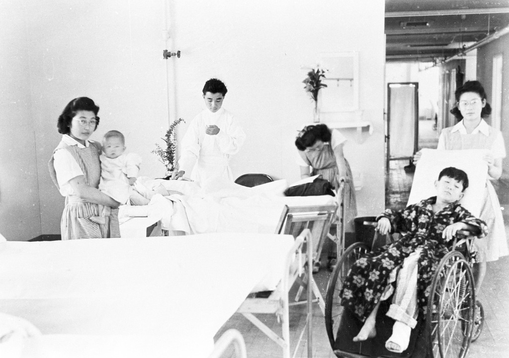 Original WRA caption: High school students working part time as nurses' aides in the hospital and as orderlies.