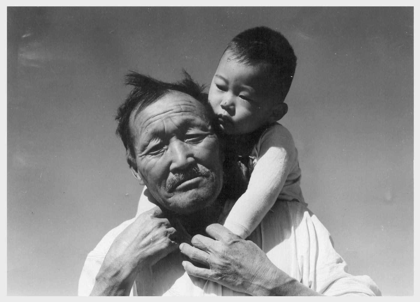 : Manzanar Relocation Center, Manzanar, California. Grandfather and grandson of Japanese ancestry at this War Relocation Authority center.