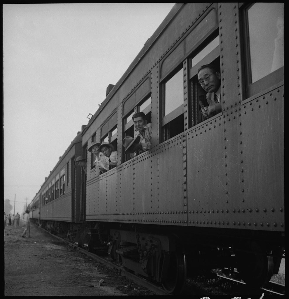 May 20, 1942. Woodland, California. Original caption: Evacuees of Japanese ancestry from this rich agricultural district are on their way to Merced Assembly center. This special train consists of ten cars.