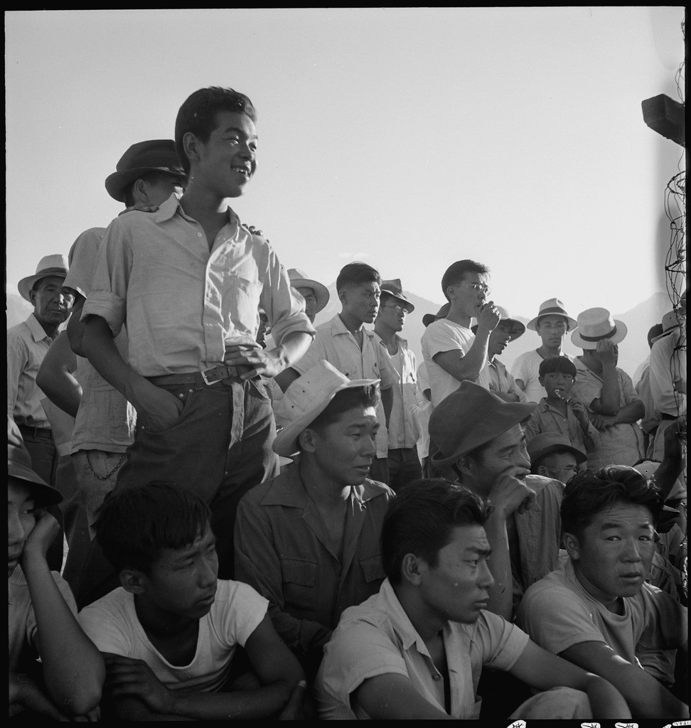 Onlookers watch a baseball game at Manzanar concentration camp. Photo by Dorothea Lange. 