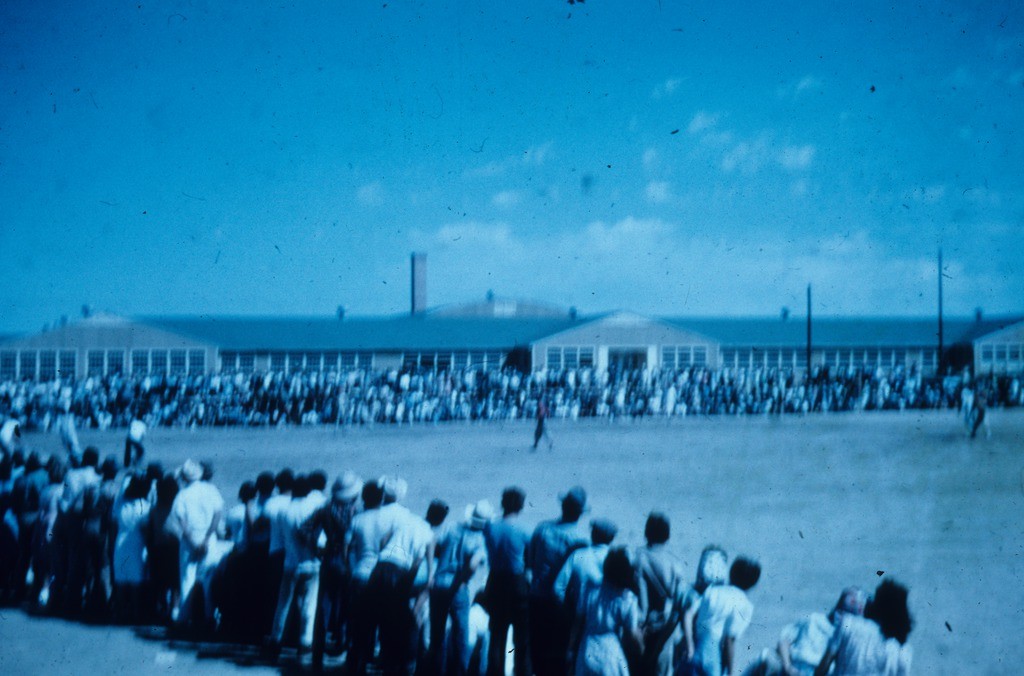 Onlookers take in a baseball game at Granada (Amache) concentration camp. 