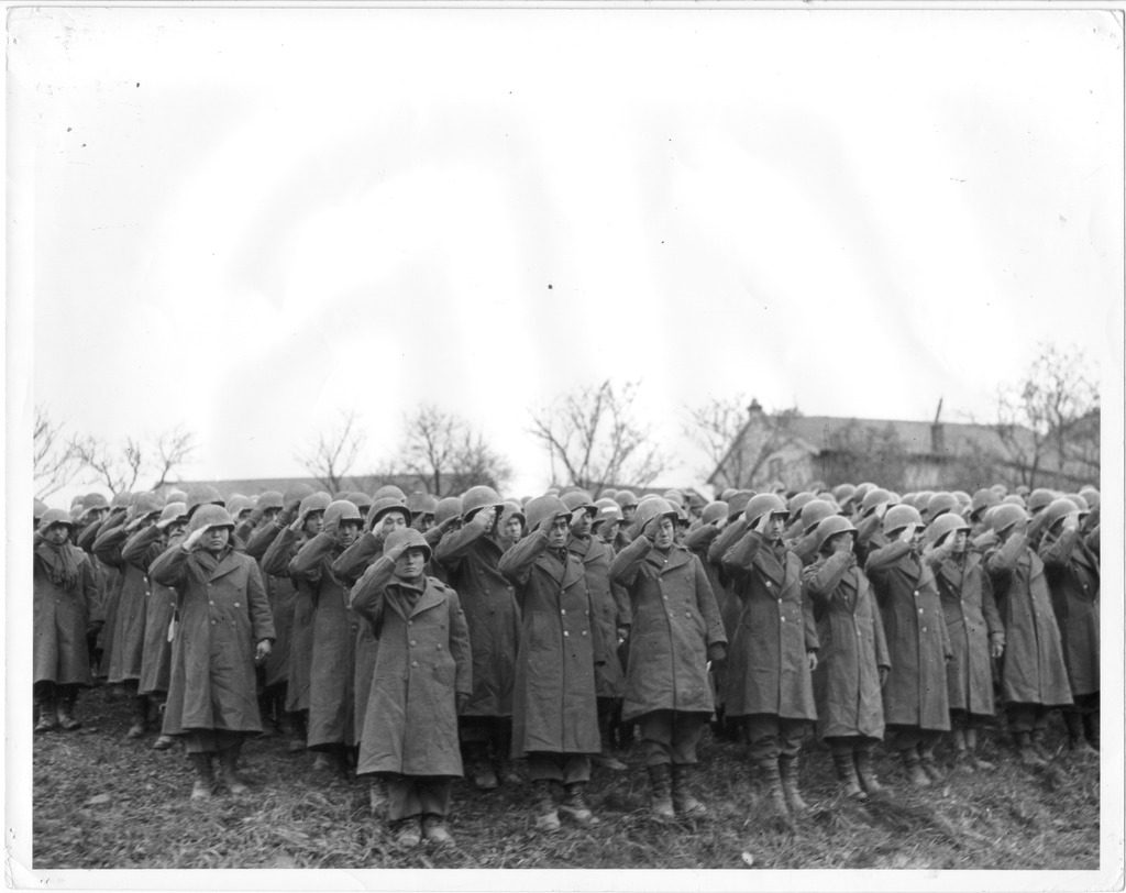 Japanese American soldiers of the 442nd Regiment Combat Team, 2nd Battalion, salute as the American national anthem is played at the finale of the Memorial Day services held at the front, in France, November 1944.