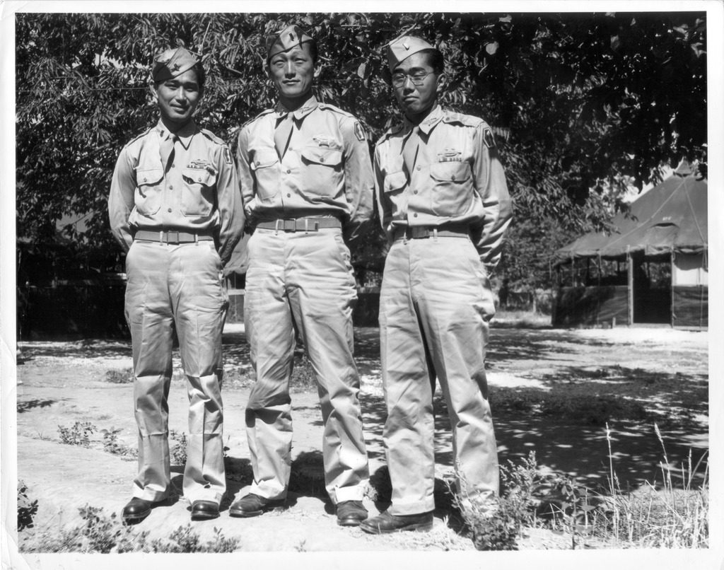 Three Japanese American soldiers of the 442nd standing in uniform.