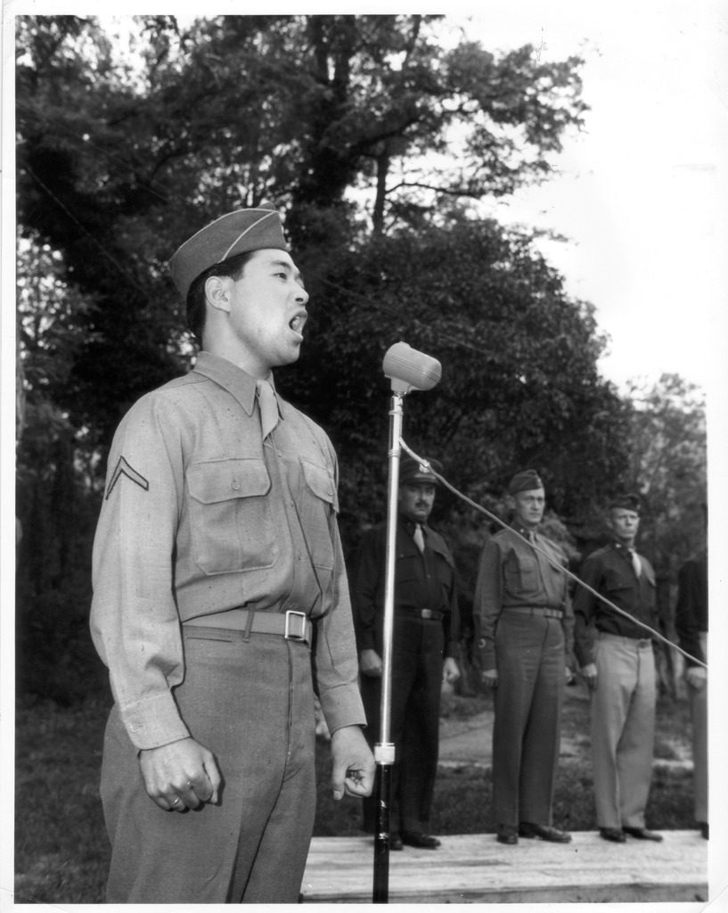 Japanese American soldier singing "God Bless America" at a ceremony in 1945.