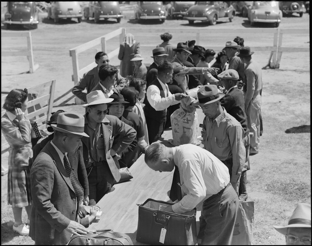 Japanese Americans having their baggage inspected upon arrival at the Turlock Assembly Center.