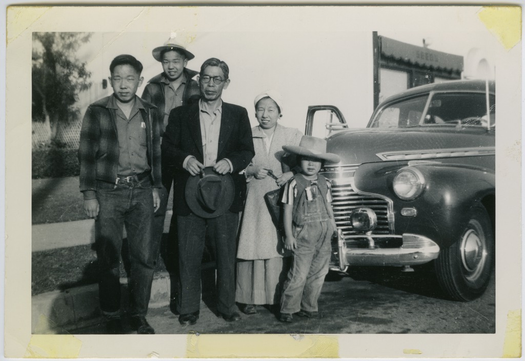 Hatchimonji family posing in front of their car, about to leave for the Pomona Assembly Center.