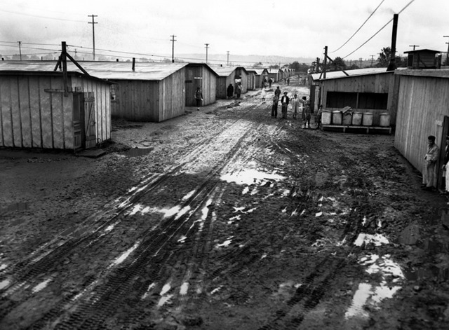 A muddy street between barracks at the Puyallup Assembly Center.
