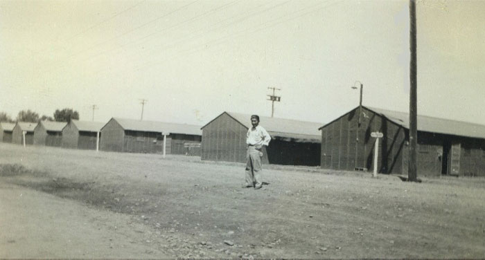 Prisoner Norman Satow in front of the barracks at Merced Assembly Center, California, June 1942.
