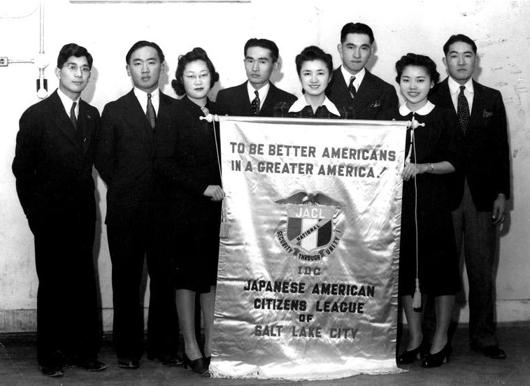 The Salt Lake City chapter of the Japanese American Citizens League holding a banner that reads "To Be Better Americans in a Greater America!"