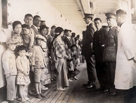 Japanese immigrants being examined by U.S. immigration officials aboard a ship docked at Angel Island.