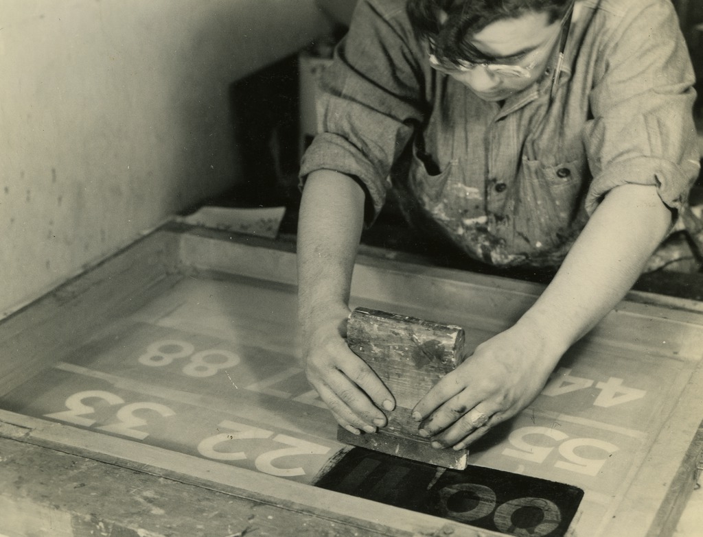 Japanese American working on a project in the Amache silk screen shop.