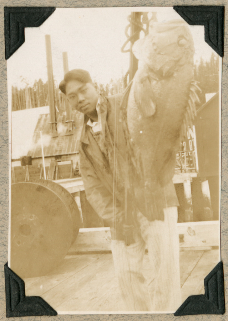 Photo of a Japanese American man posing with a large fish.