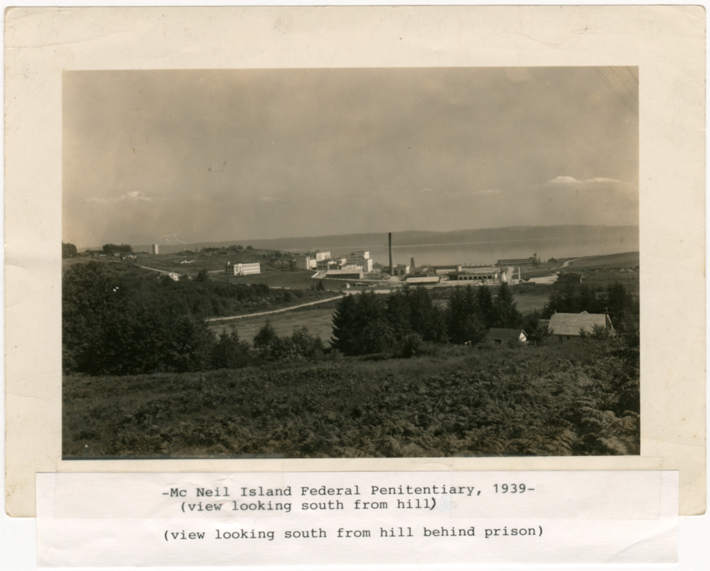 Photo of the McNeil Island Federal Penitentiary buildings, taken from a distance.