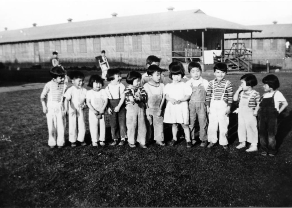 Thirteen incarcerees at the Manzanar Children's Village. Original photograph inscription: