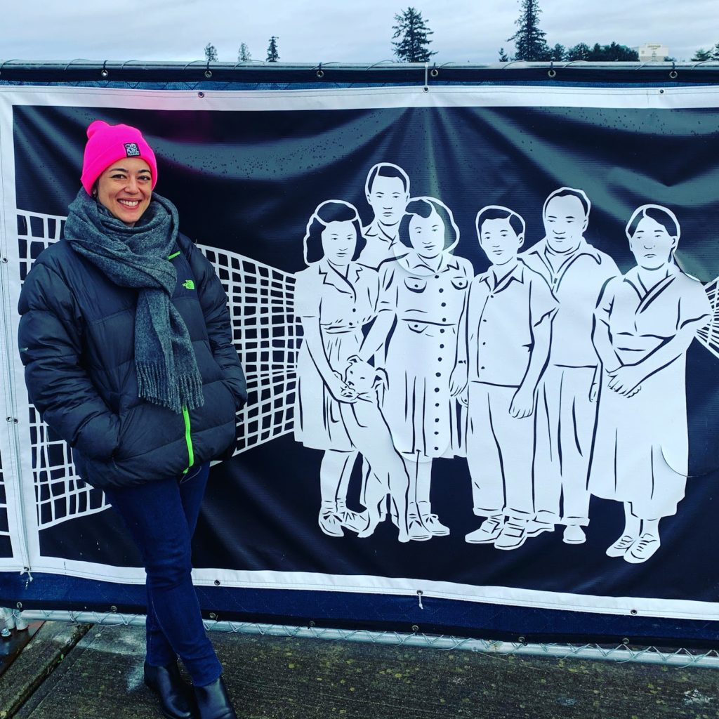 Iida with a portion of her recently installed 120 foot long mural for Sound Transit in Federal Way, Washington. Photo courtesy of the artist.