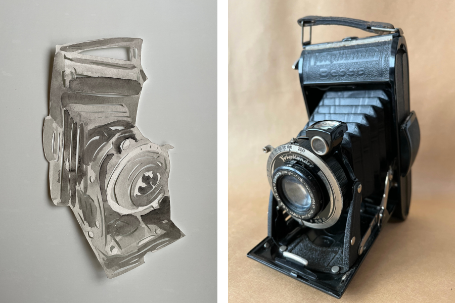 Paper cut out of a vintage folding camera next to a photo of the actual camera.