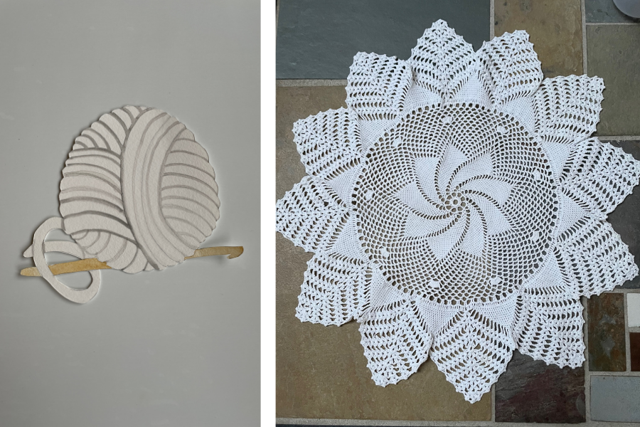 White cotton doily with a windmill design next to a paper cutout of a ball of thread and crochet hook.