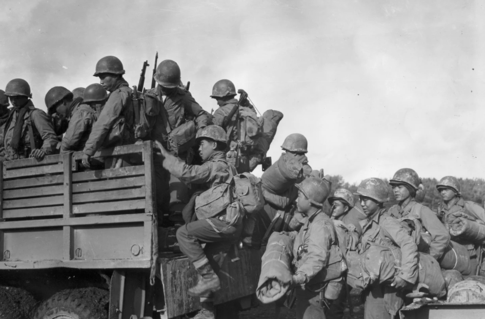 Japanese American troops in the segregated 442nd Regimental Combat Team climb into a truck at a military campsite in France during World War II. Seattle Nisei Veterans Committee and U.S. Army via Densho
