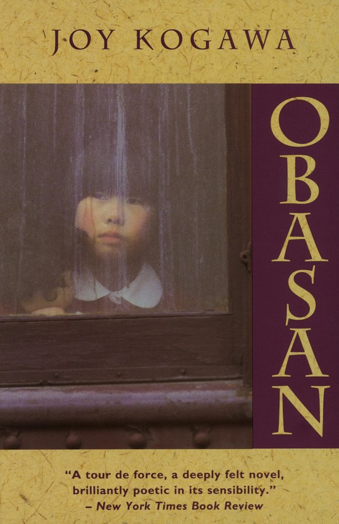 Book cover of Obasan by Joy Kogawa. It shows a young Japanese American girl looking out a rain streaked window.