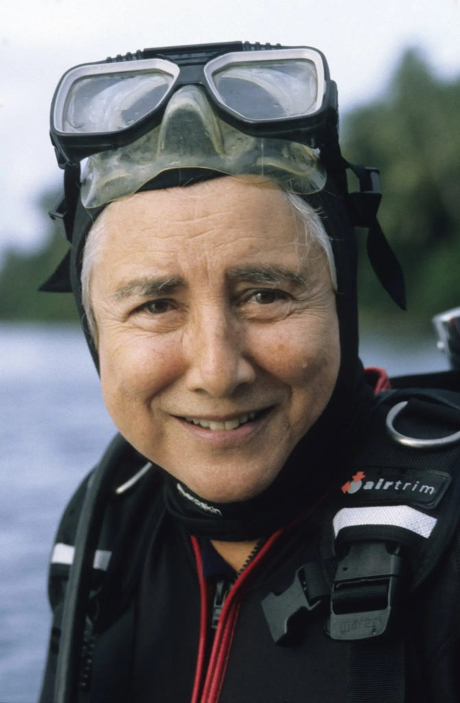 Eugenie Clark wearing SCUBA gear. She is pictured from the shoulders up and smiling.