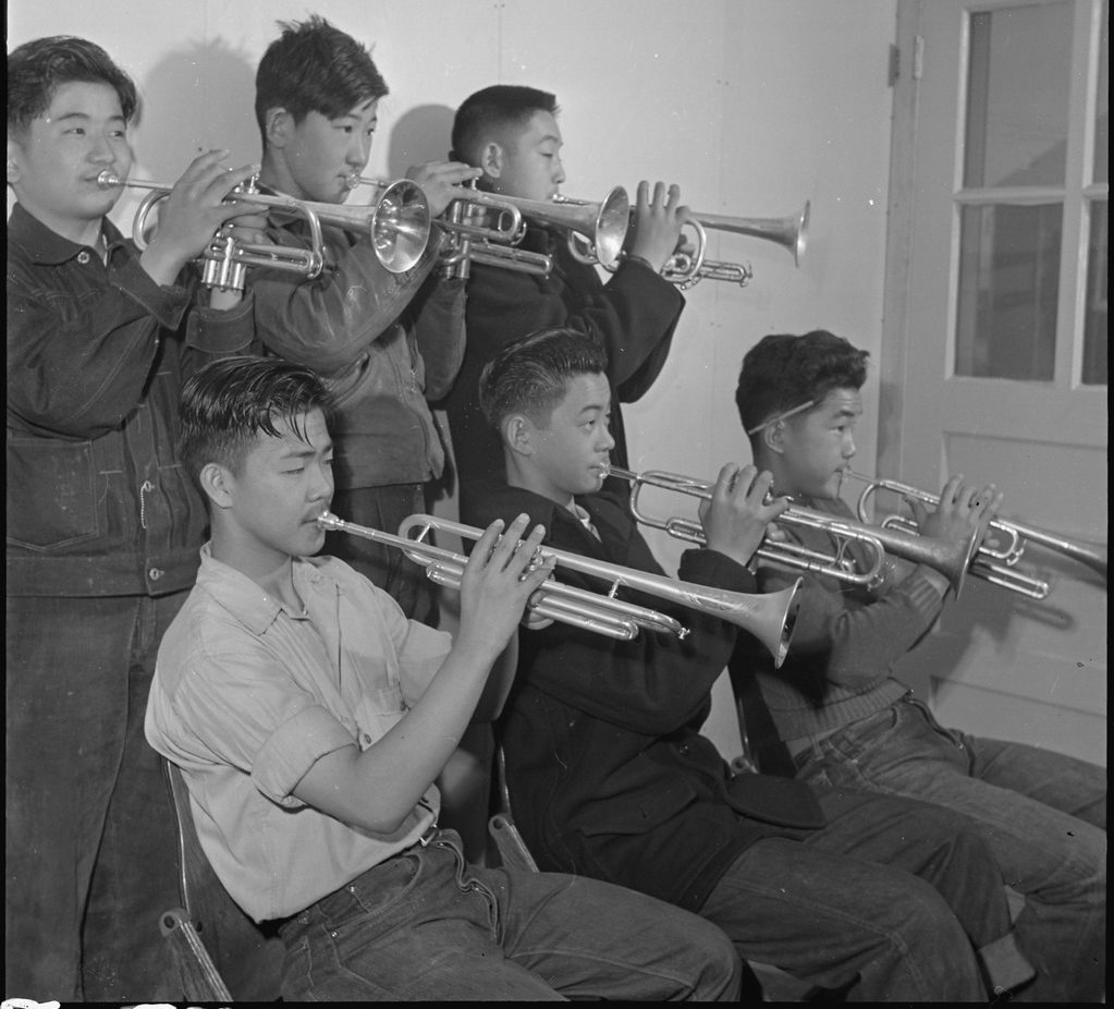 Six Japanese American high school students playing in a brass band in Rohwer concentration camp.