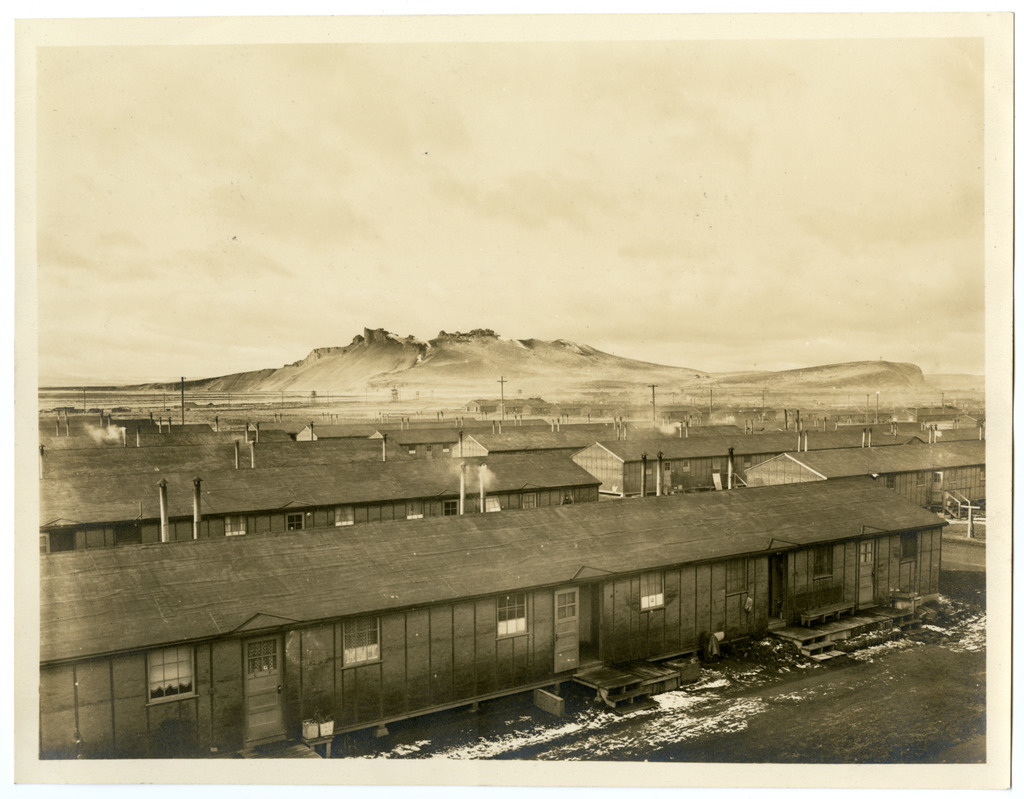 View of barracks at Tule Lake concentration camp, with hills in the distance