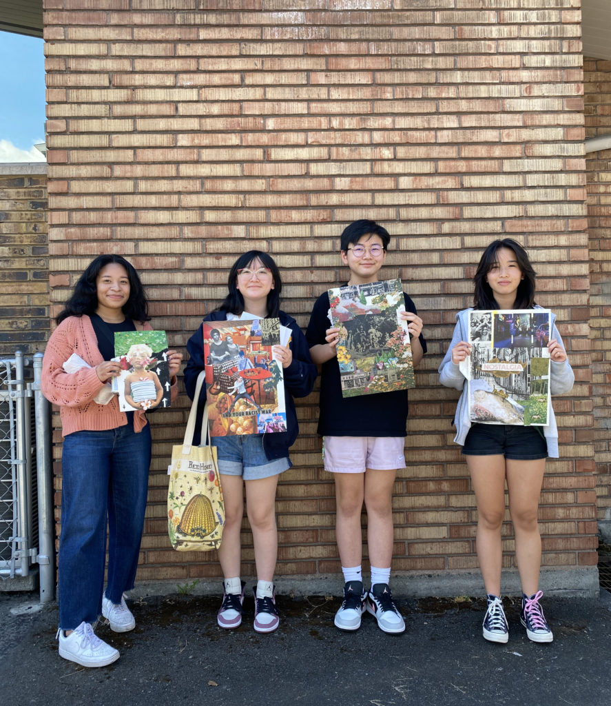 Four teens standing against a brick wall outside the Densho building holding collages they made.
