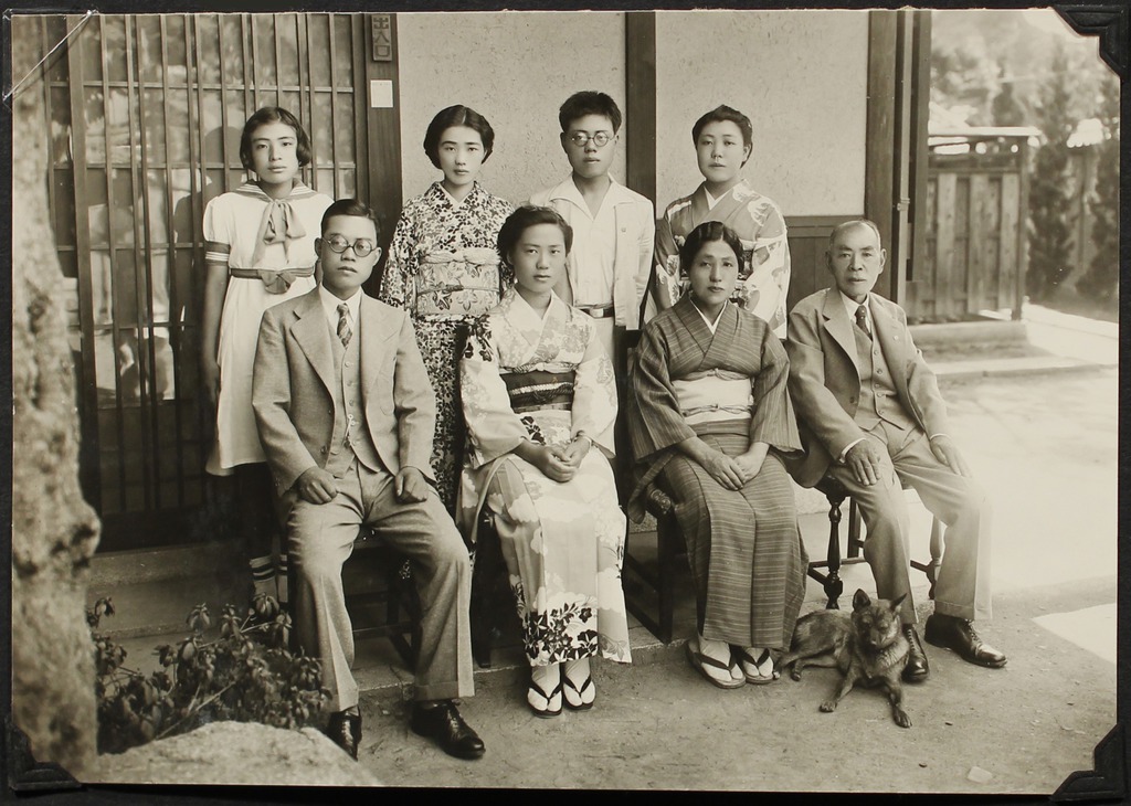 A Japanese and Japanese American family posing for a photo outside their home in Japan in 1940.