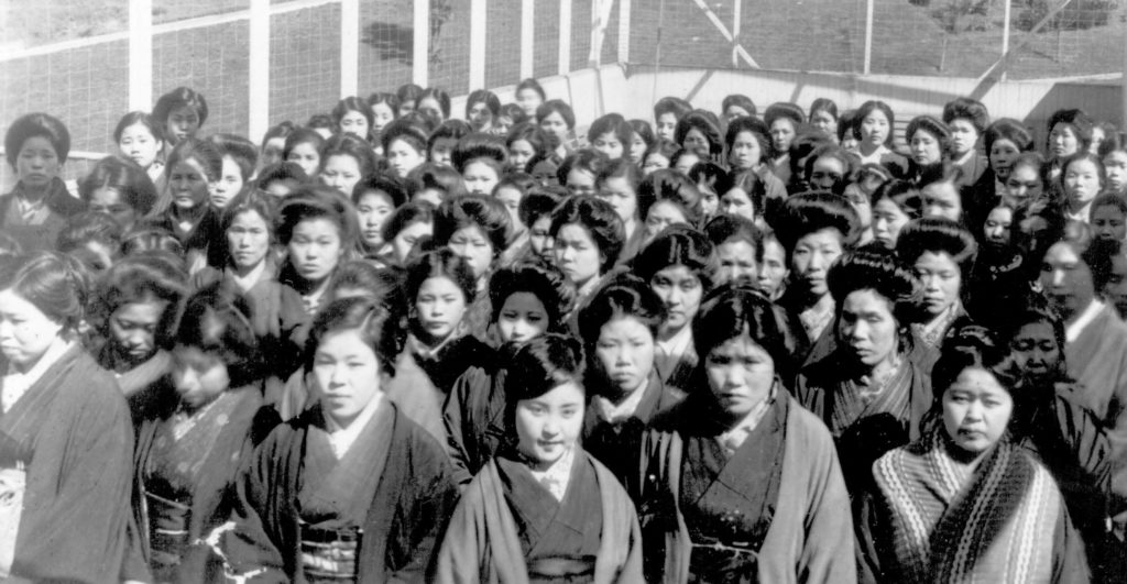 A large group of picture brides arriving at the Angel Island immigration station, c. 1910.