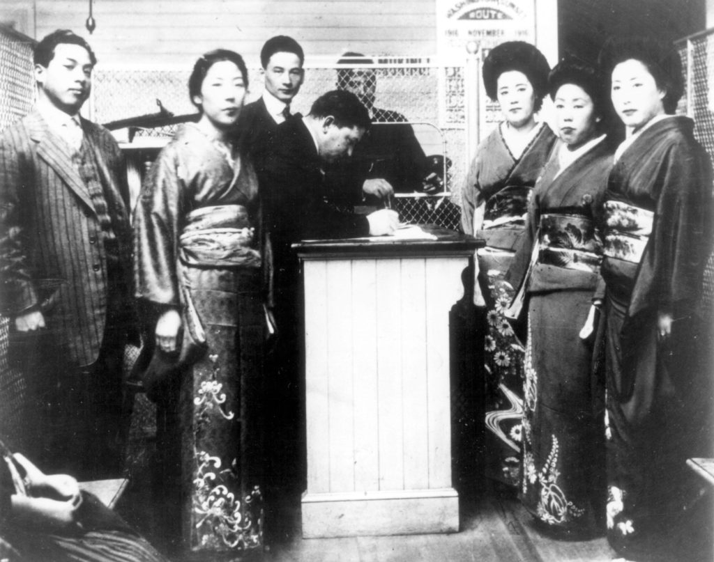 Four Japanese picture brides being processed at the Angel Island immigration station, circa 1910.