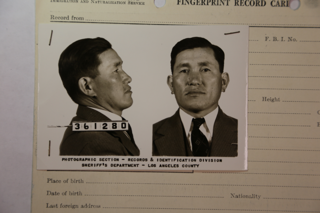 Booking photo of a Japanese American man arrested in 1942.