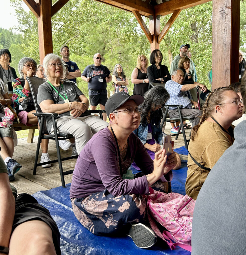 Members of the bus tour listen to a talk at the Nikkei Legacy Park in Greenwood, British Columbia, an abandoned copper mining town that housed Japanese Canadian fishing families from Steveston in 1942.
