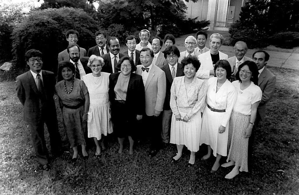 Members of the Hirabayashi, Korematsu and Yasui legal teams pose for a group photo at a celebration in Seattle. Gordon Hirabayashi stands at the center of the group.