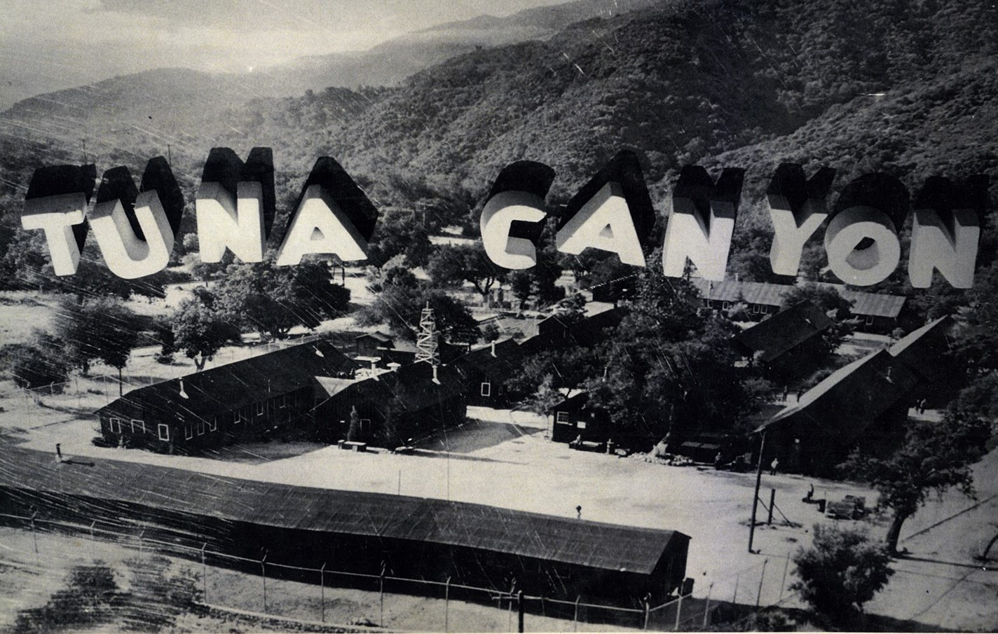Model of Tuna Canyon Detention Facility with barracks and a sign in the hills behind the camp that reads "Tuna Canyon"