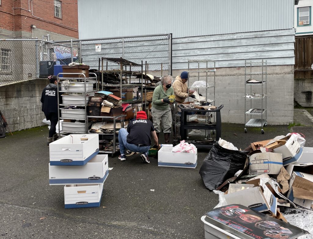 Densho staff sort through items salvaged from the Seattle Betsuin's archives after the fire.