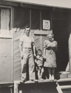 Elaine, Karl, and Tommy in front of their barrack in Manzanar