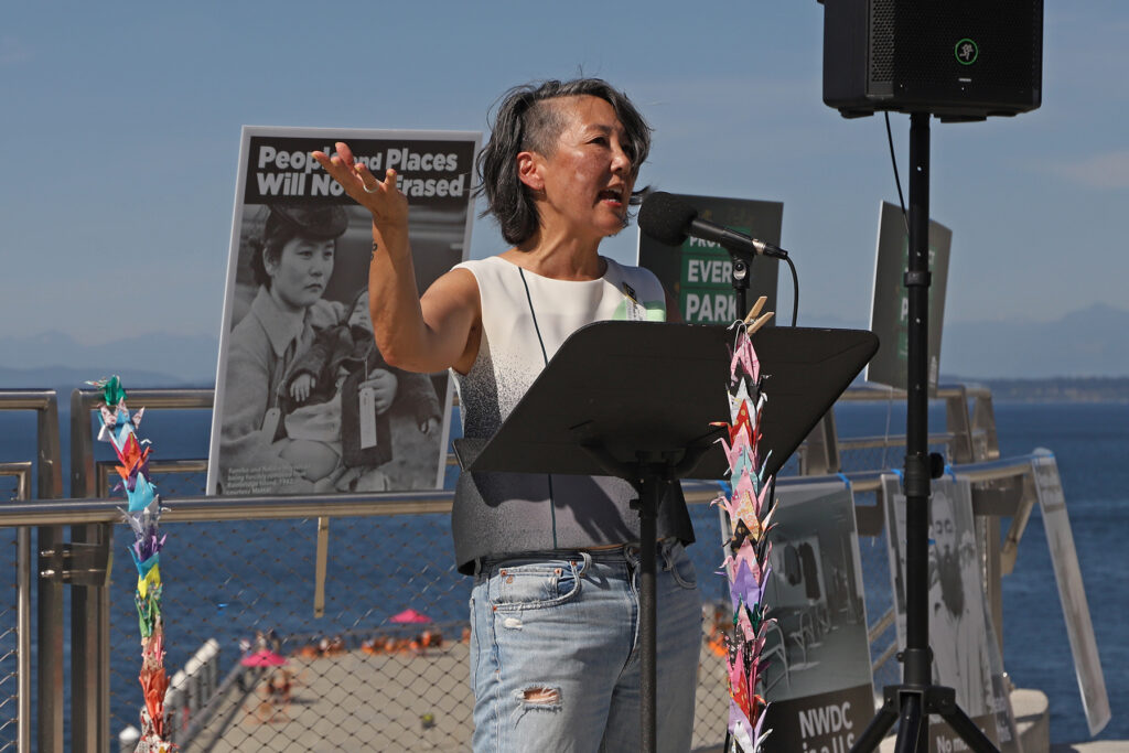 Erin Shigaki speaks at a podium during the Protect Every Park Day of Action