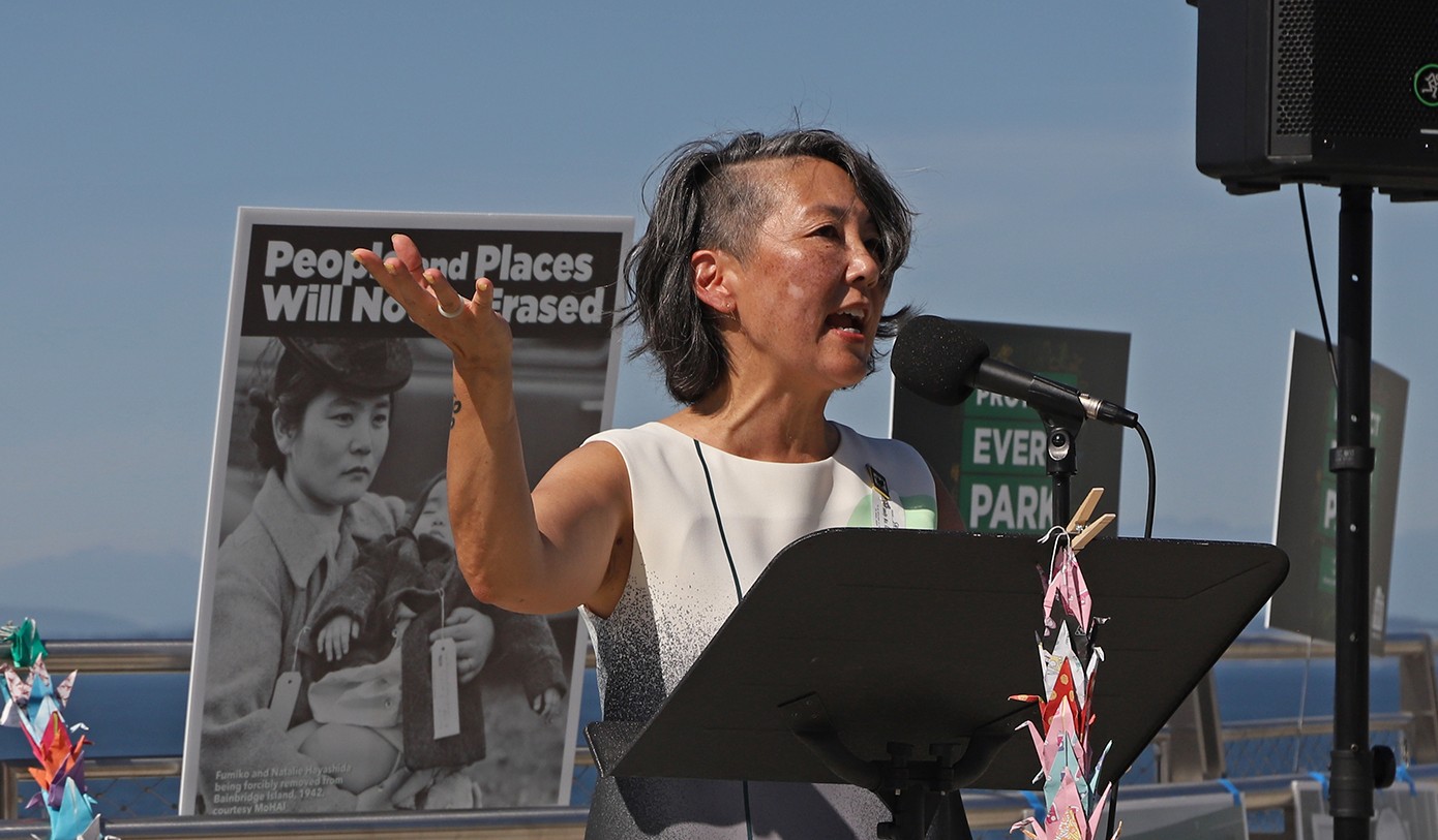 Erin Shigaki speaks at a podium during the Protect Every Park Day of Action