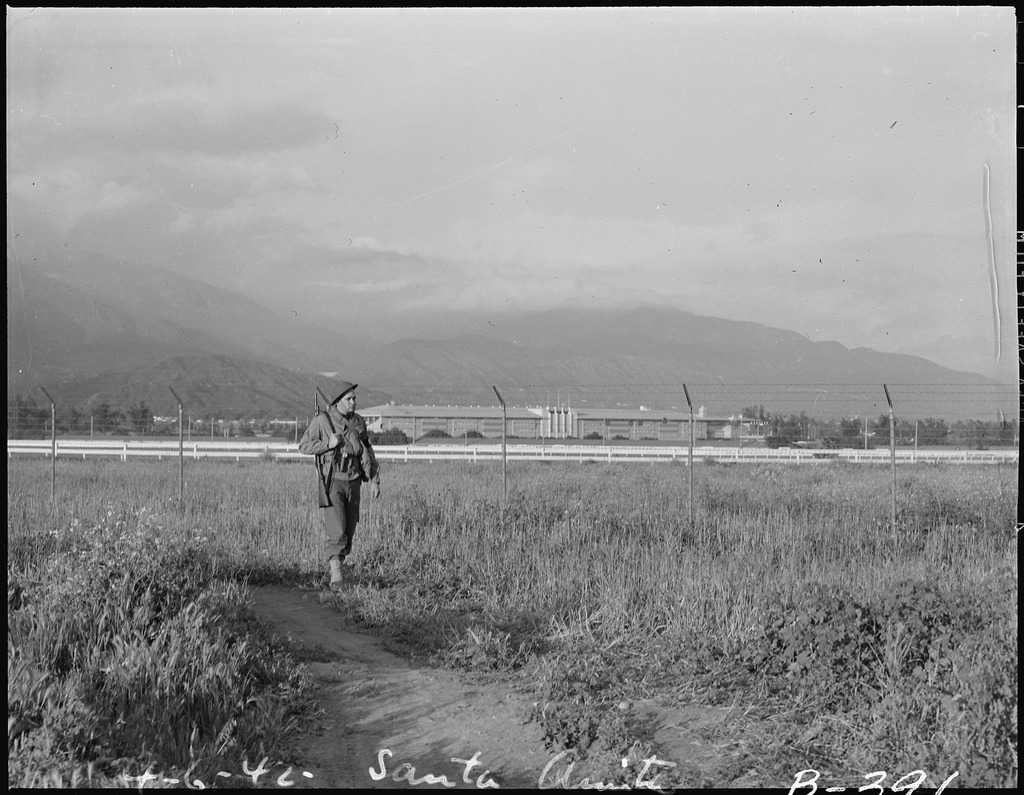 Military policeman patrolling camp fence at Santa Anita Assembly Center