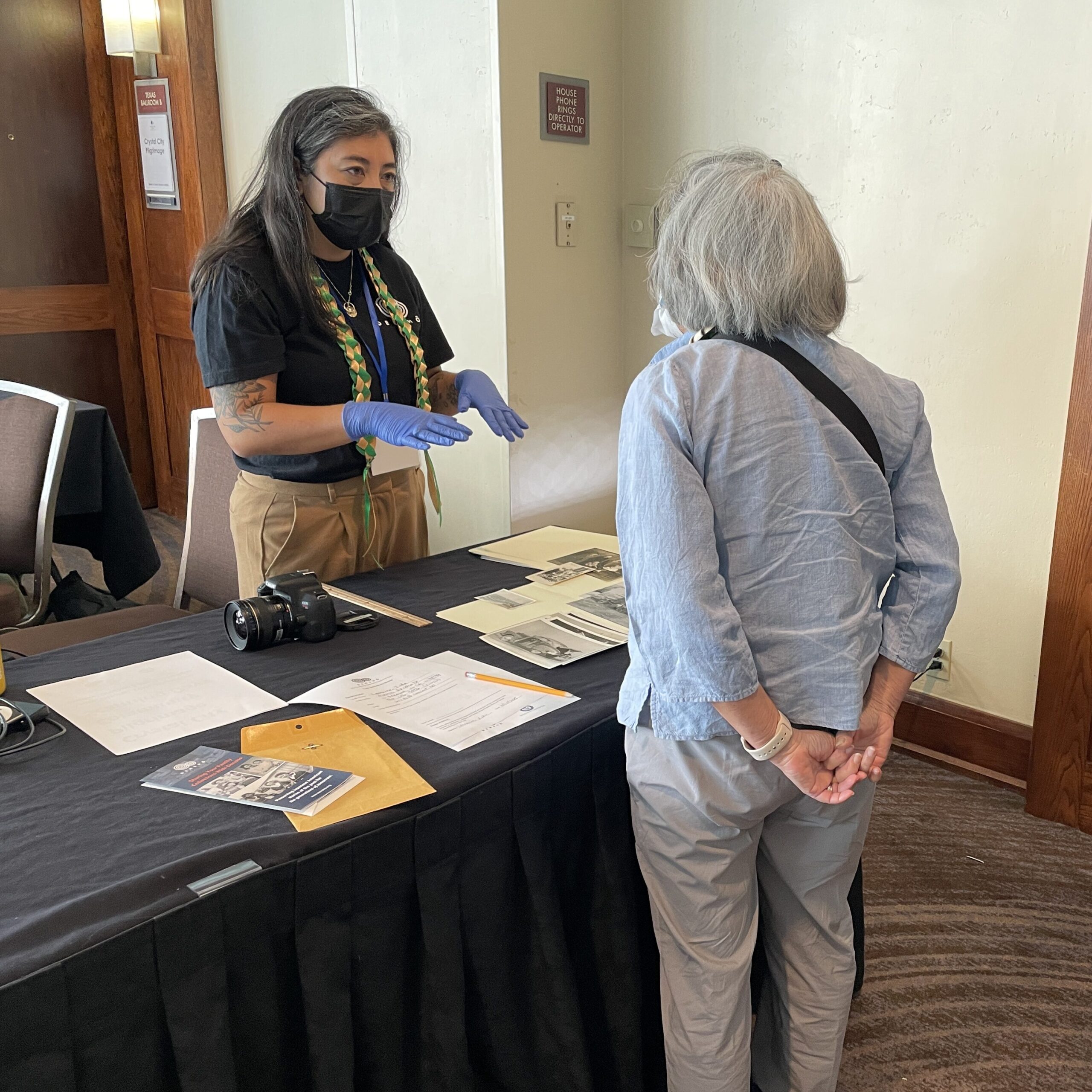 Archives Director Caitlin Oiye Coon works with a pilgrim to scan their family’s photographs as part of Densho’s Community Scanning Program.