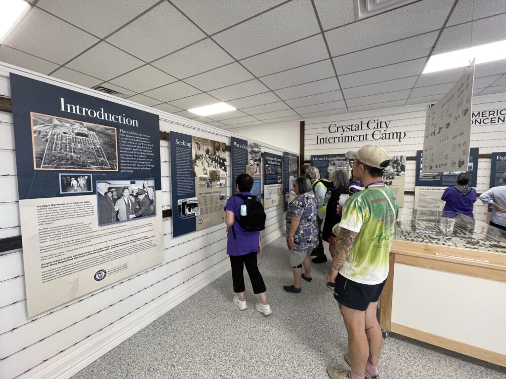 Pilgrims view the Crystal City Internment Camp exhibit at the My Story Museum.