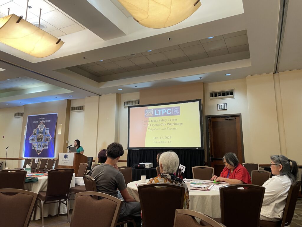 Natalie A. Sanchez-Lopez of the Latino Texas Policy Center speaks in front of a crowd. 