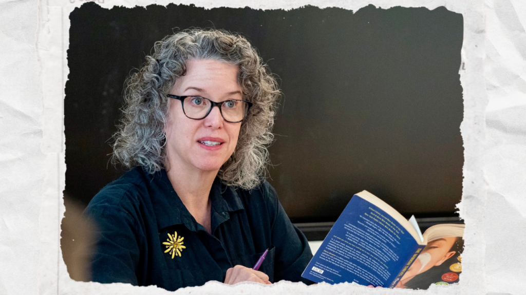 Tamara Bunnell holding book, looking at audience.