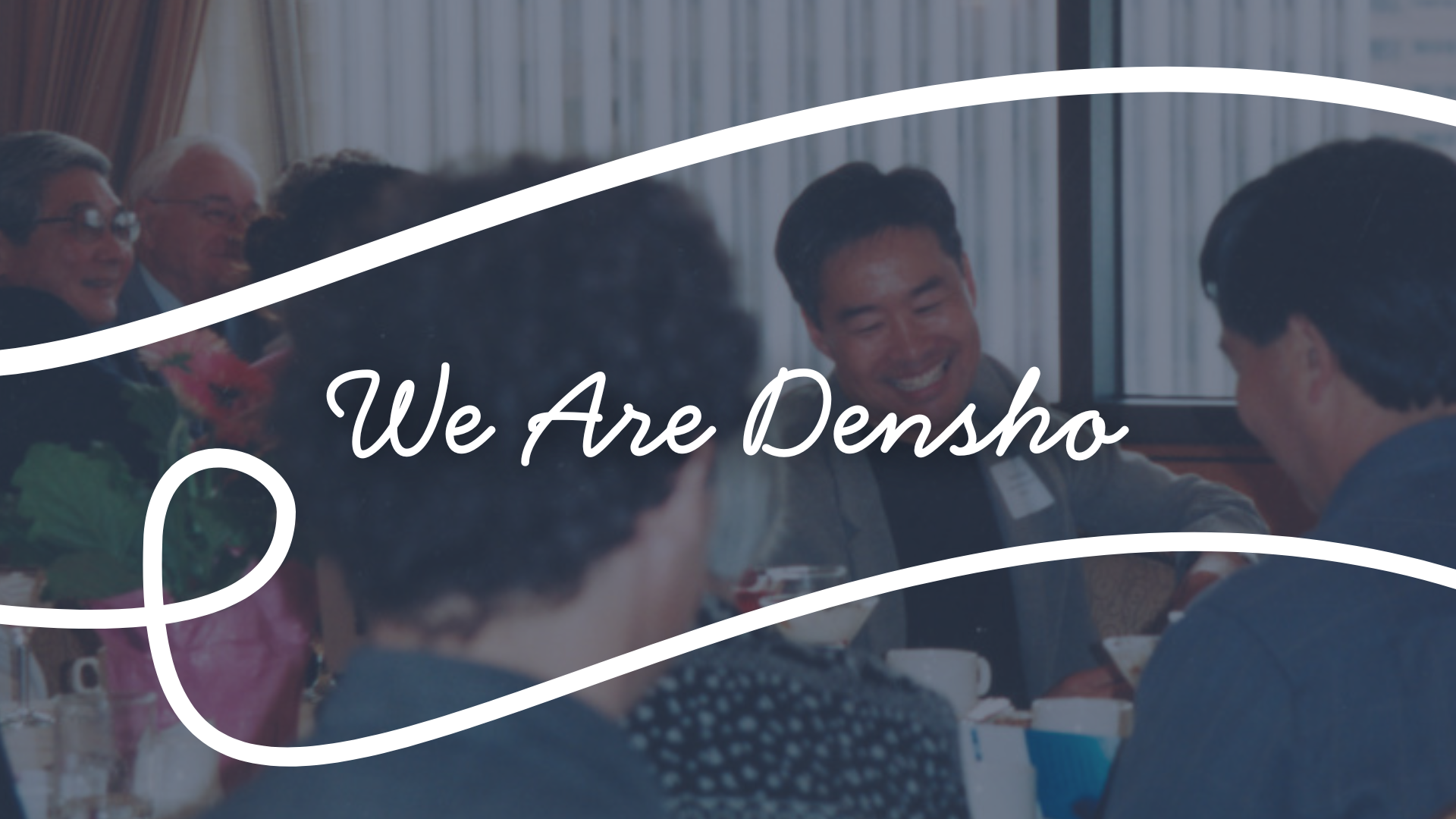 "We Are Densho" written over photo of Tom Ikeda smiling at a dinner table with others
