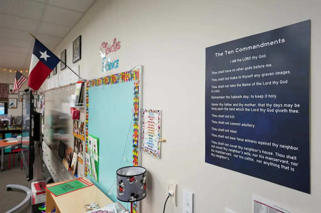 Image of a classroom with a proposed book list in Texas, which includes readings from the Bible, such as the definition of love from First Corinthians and the story of David and Goliath.