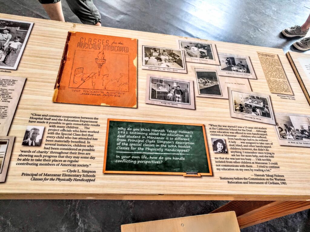 Manzanar Disability Exhibit. Various photos with texts and quotes on a sign.