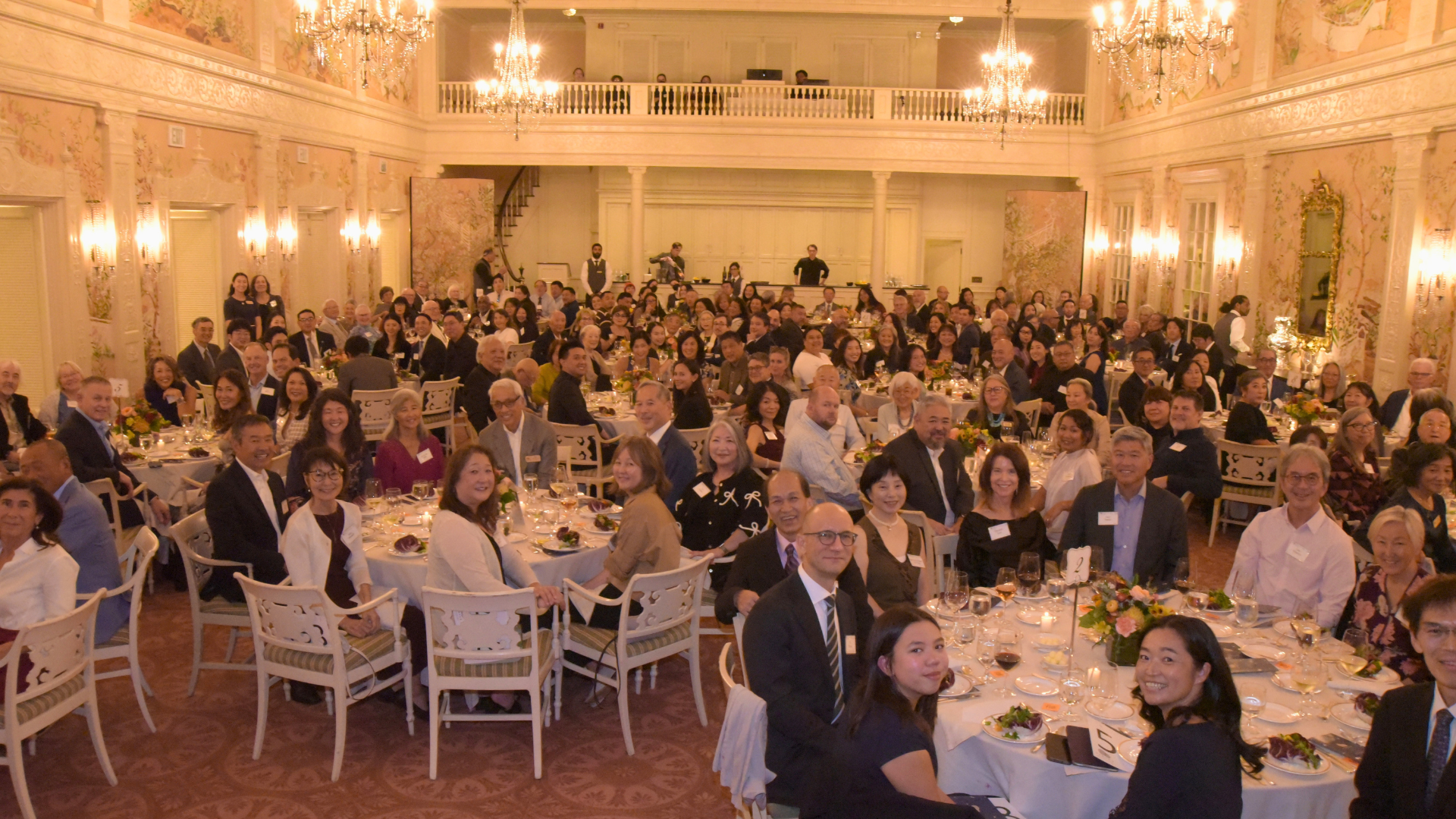 Guests and staff alike smile sitting at round tables at Densho's 30th Anniversary Gala.